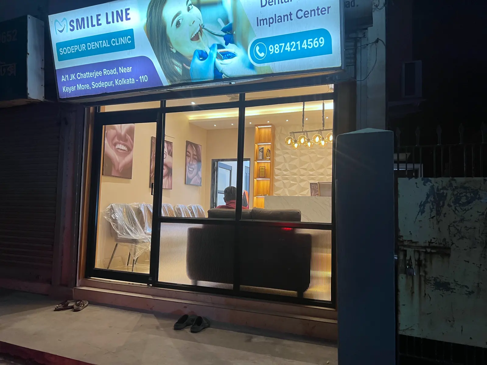 The Smile Line clinic storefront lit up at night in Sodepur