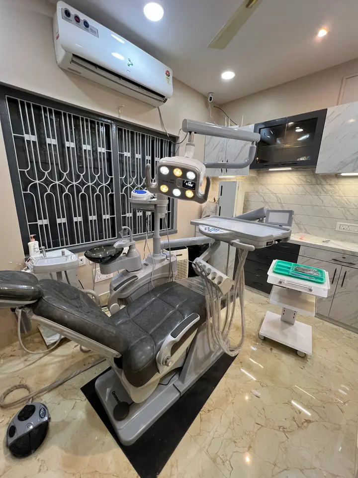 A premium grey ergonomic dental chair beside marble surfaces in a Smile Line operatory