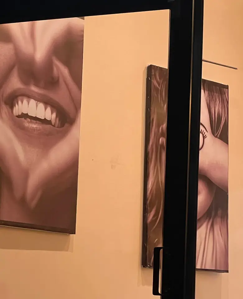 A grid of monochrome smile portraits in the clinic interior