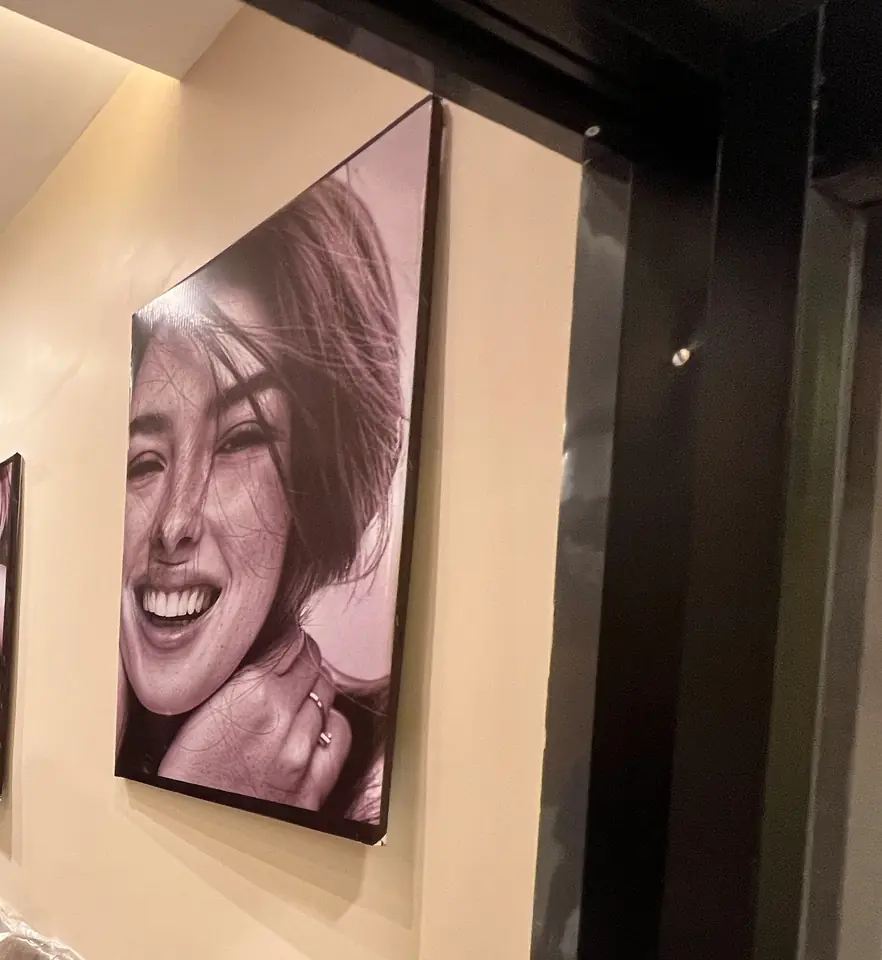 Black-and-white smile portraits arranged across the Smile Line reception wall