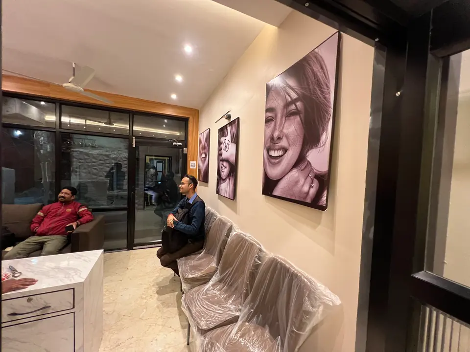 More black-and-white smile portraits lining the reception area